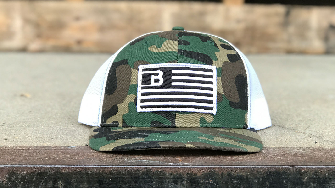 Custom logo flag patch design on matching green camo trucker 