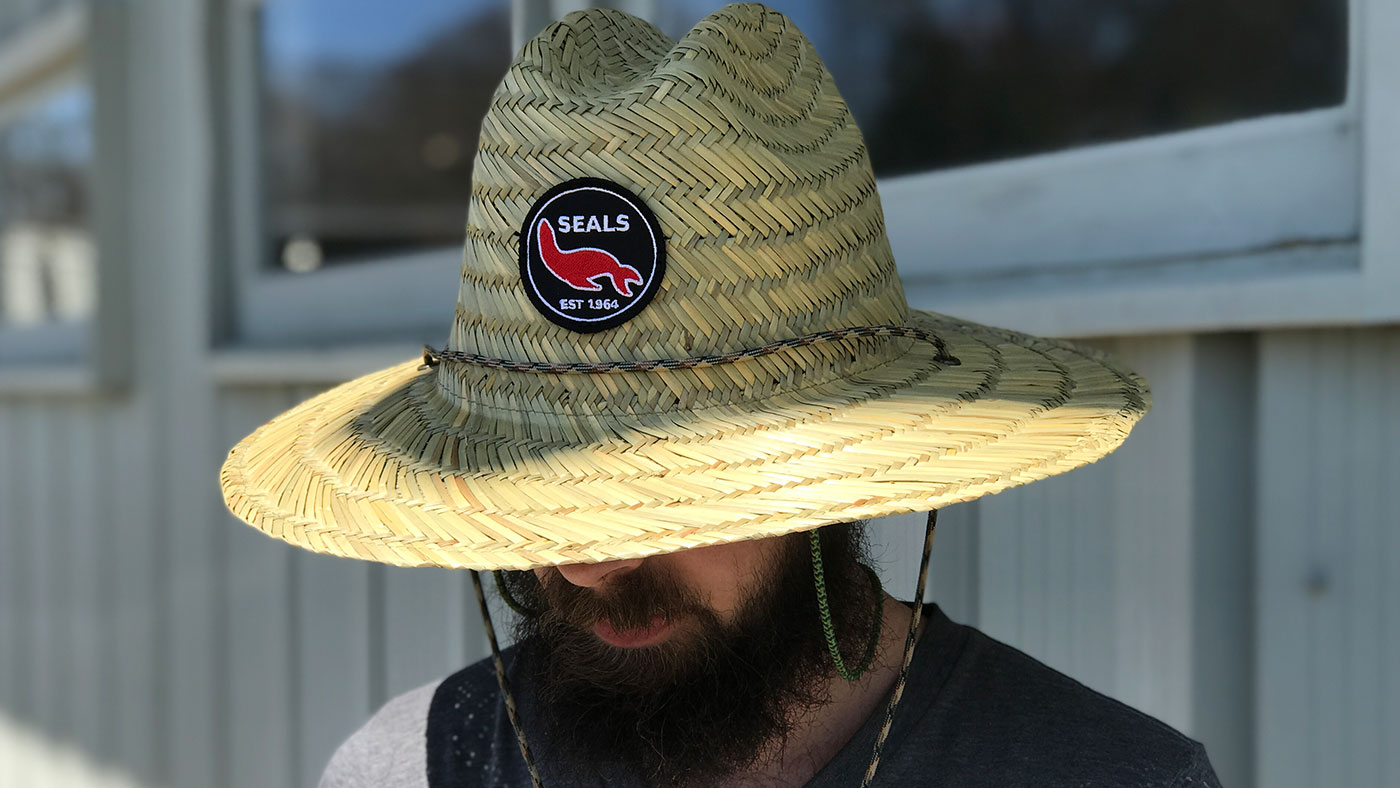 Bearded man wearing straw lifeguard hat with classic patch 