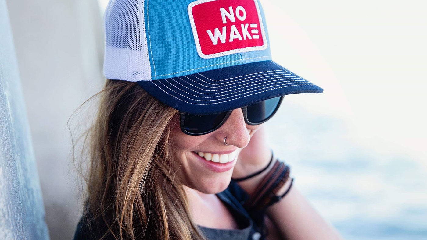 Surfer girl wearing Richardson patch hat on a boat 