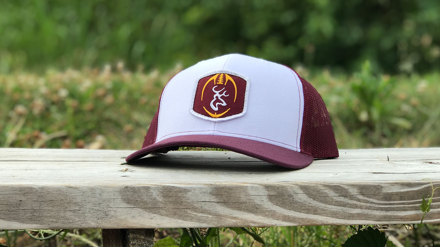 Maroon and white Richardson with matching logo on a bench
