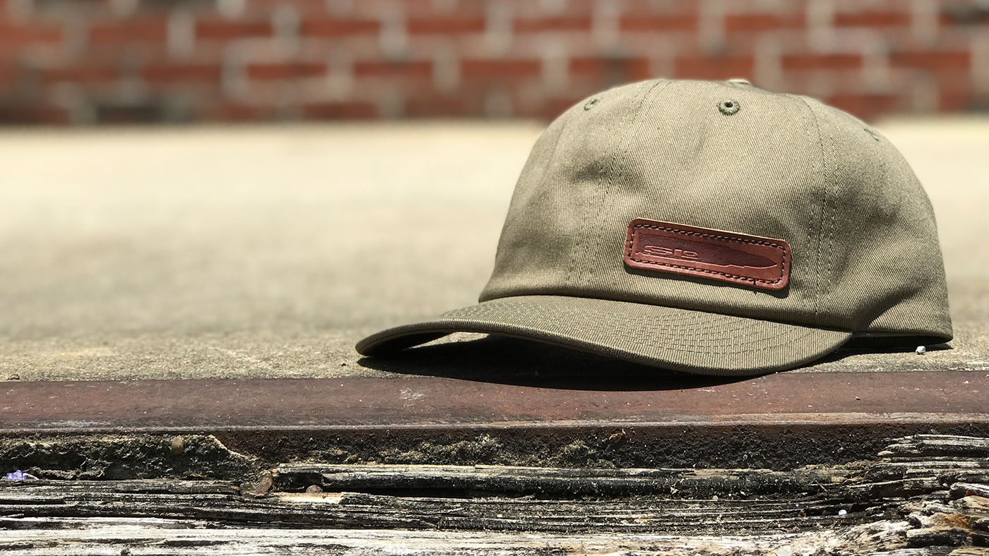Loden canvas cap with offset stamped leather patch 