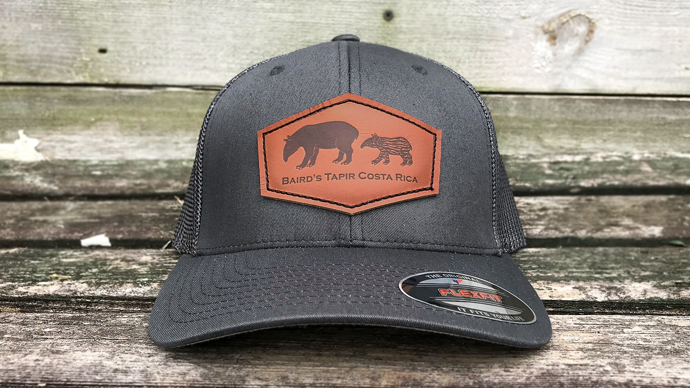 Fitted mesh cap with leather company logo and text patch