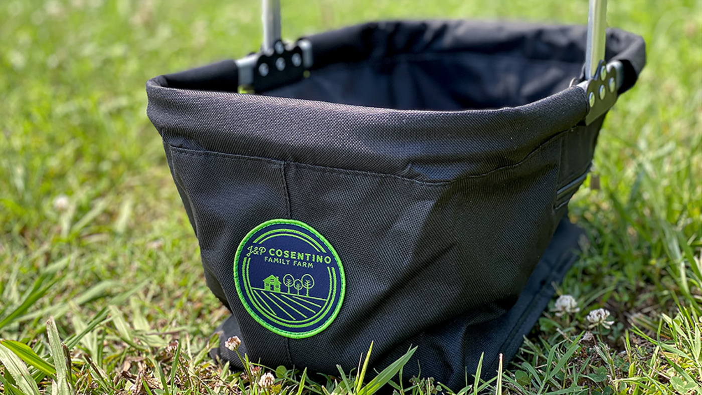 picnic basket merchandise with farm logo patch on the grass
