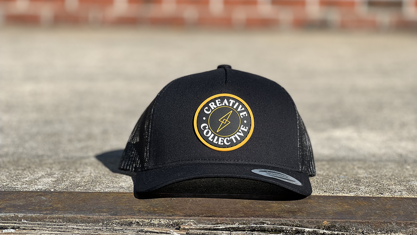 Gold border circle patch on black hat