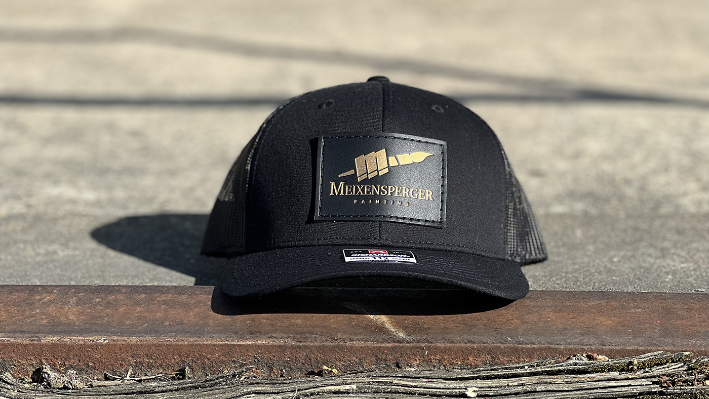 Black on black stamped leather patch hat with gold imprint 