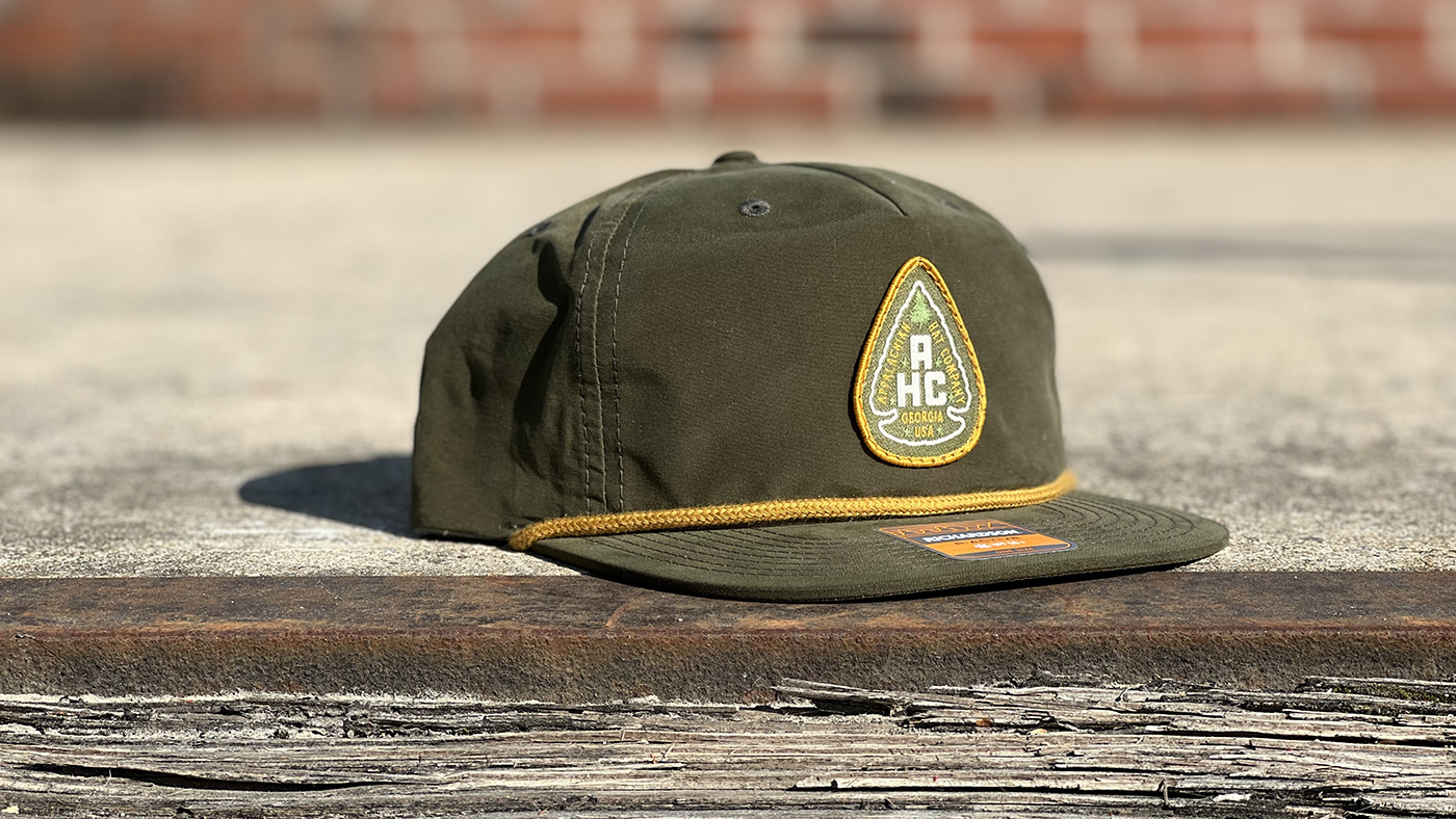 Matching green logo and hat cap with gold rope