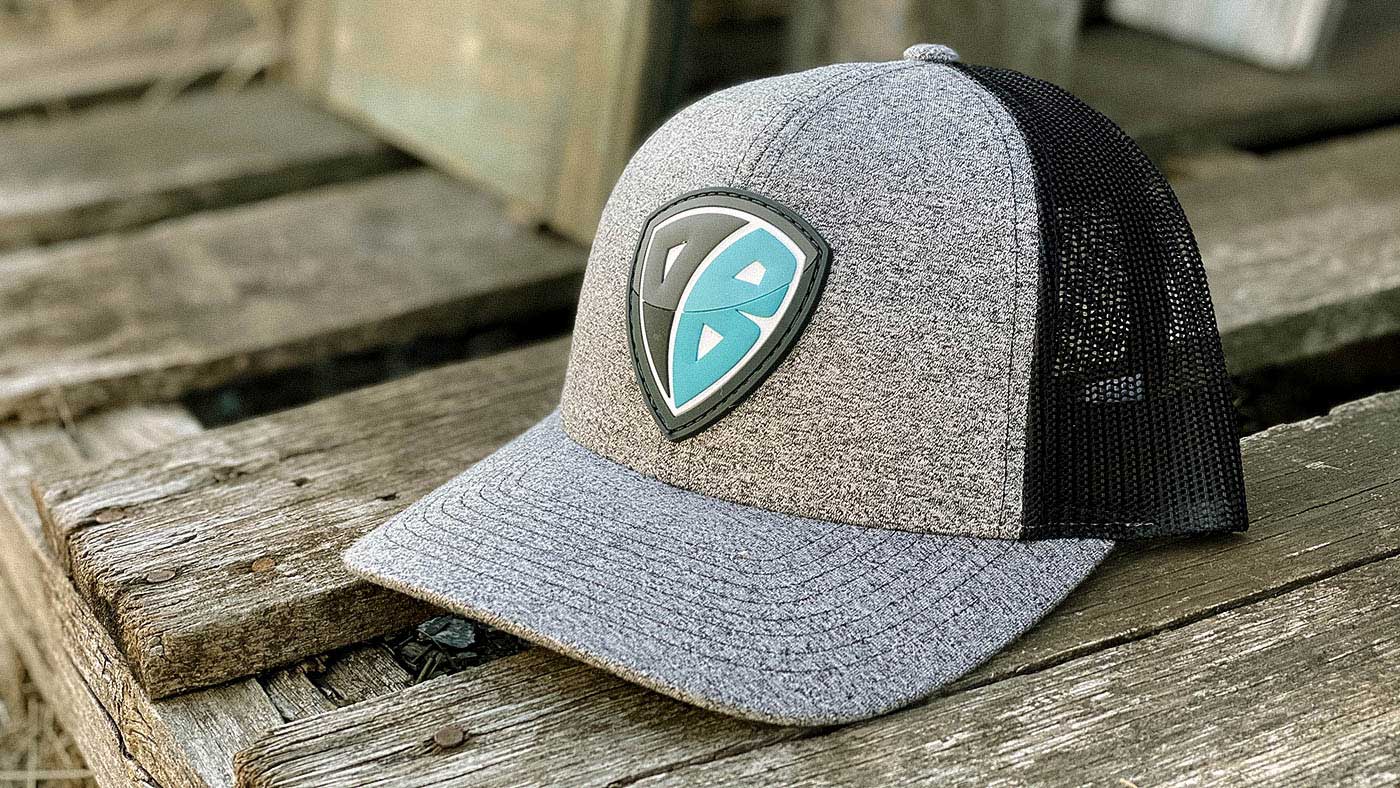 a heather grey cap with a badge shape patch at the barn