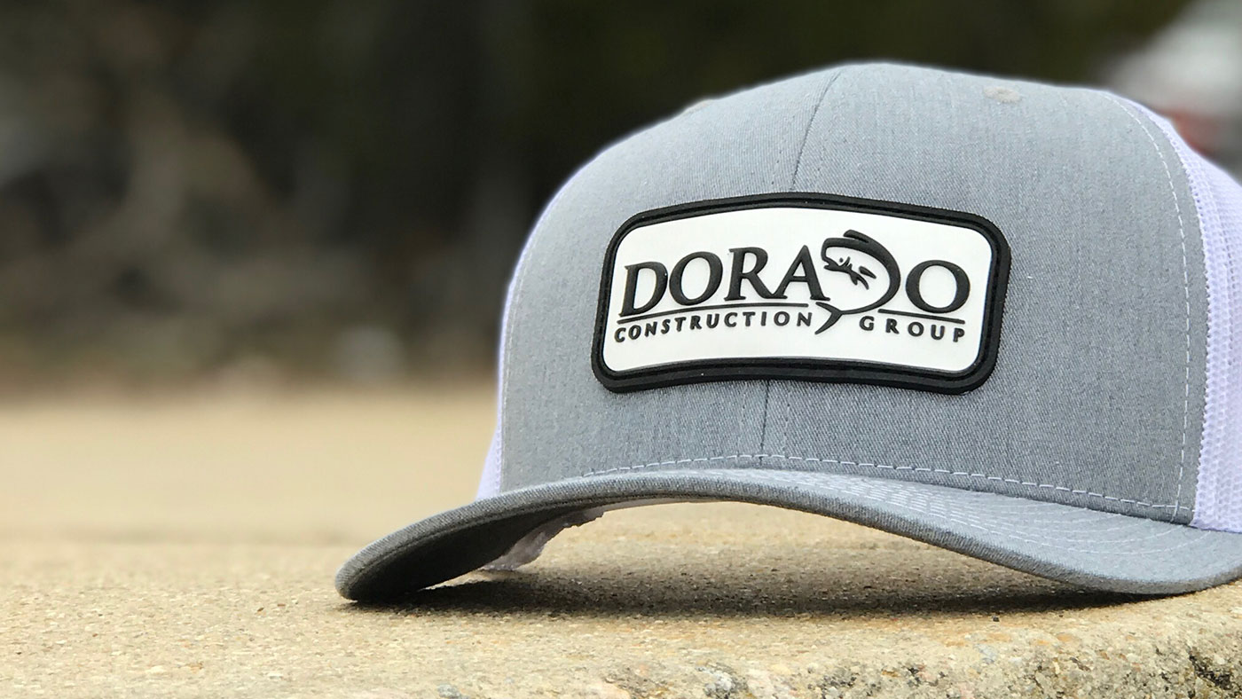 black and white pvc patch construction logo on grey hat 