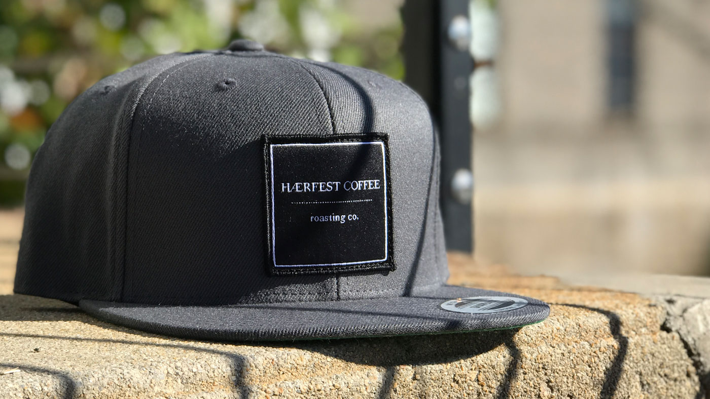 Roasting Company woven patch on a classic Yupoong flatbill 