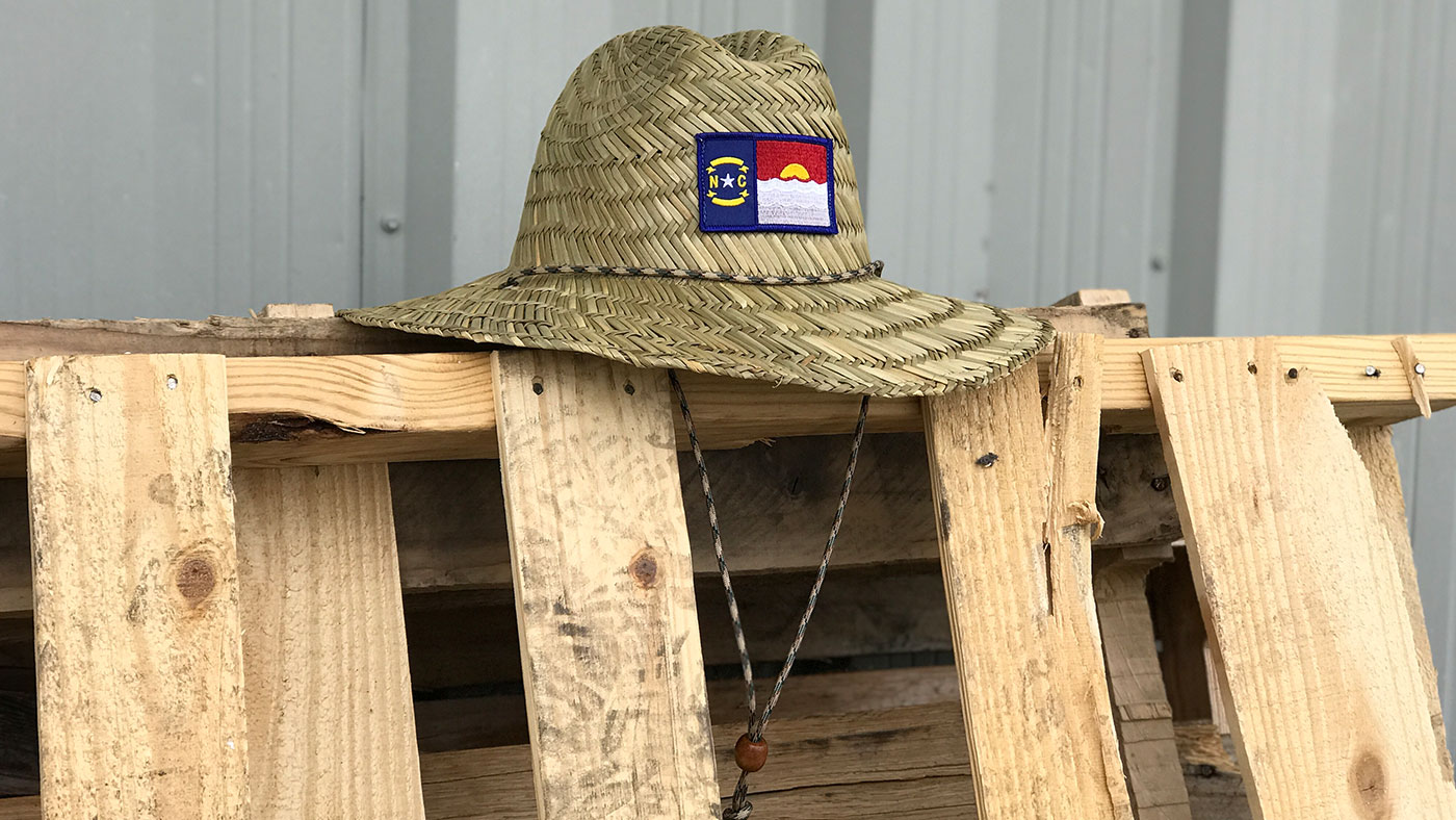 Straw hat with North Carolina State Patch