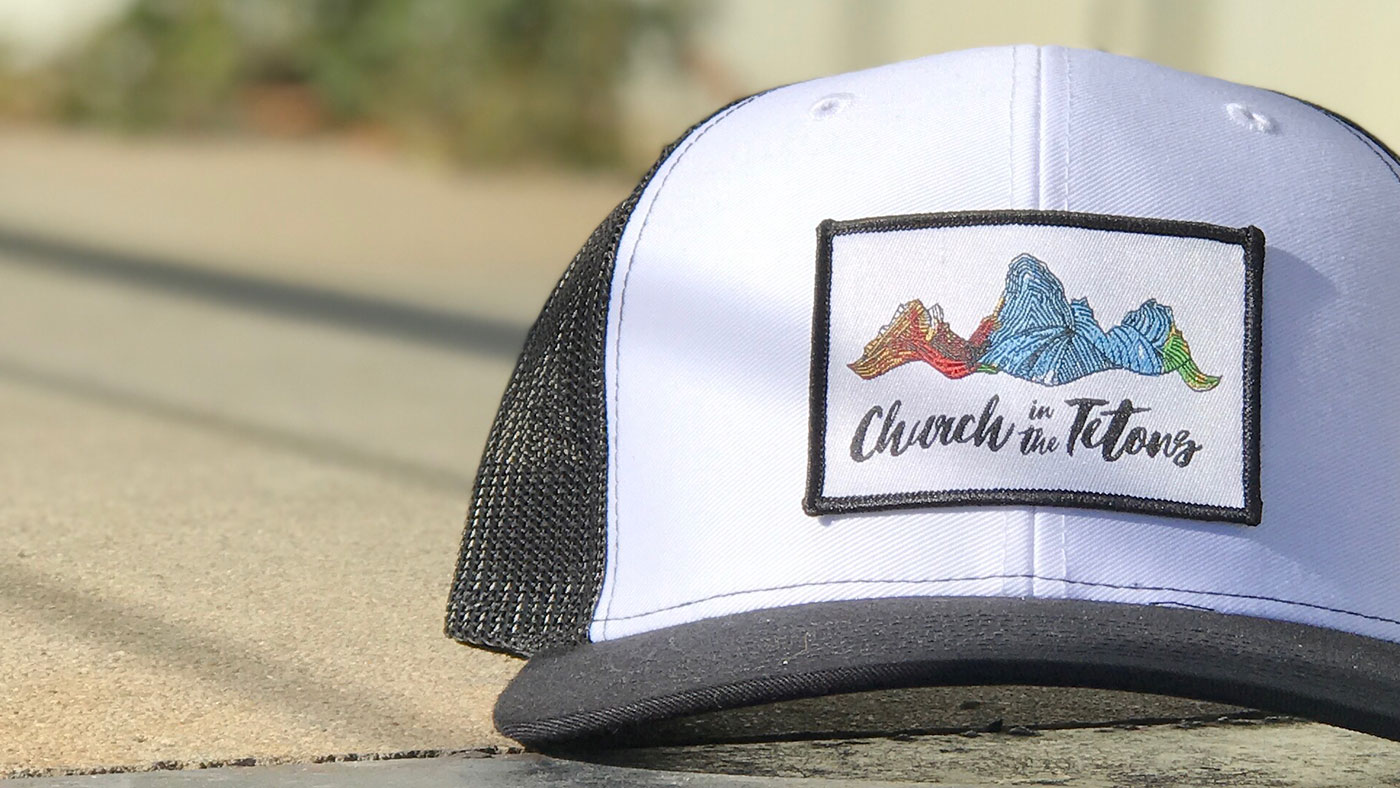 Custom Woven Patch On Hat Black and white trucker with printed color patch