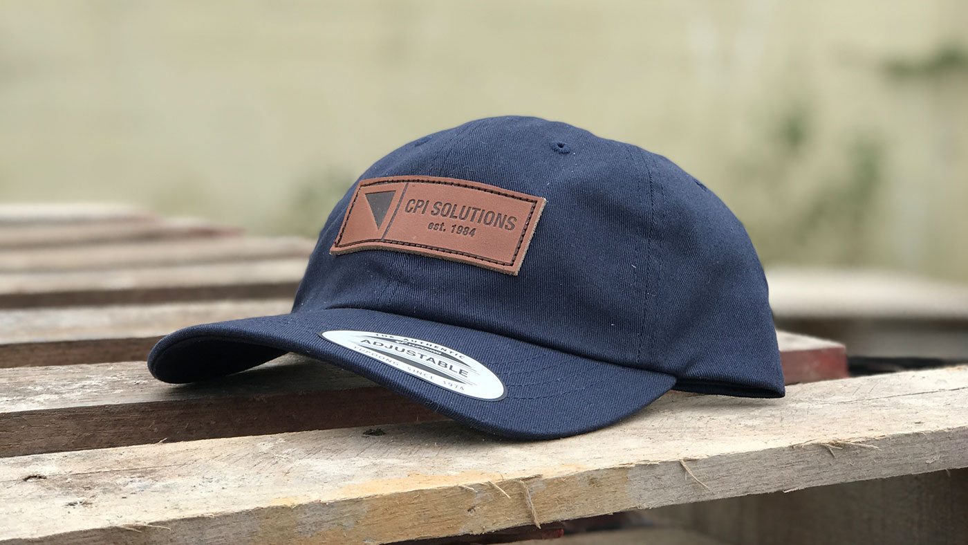 Navy unstructured baseball cap with dark brown leather patch
