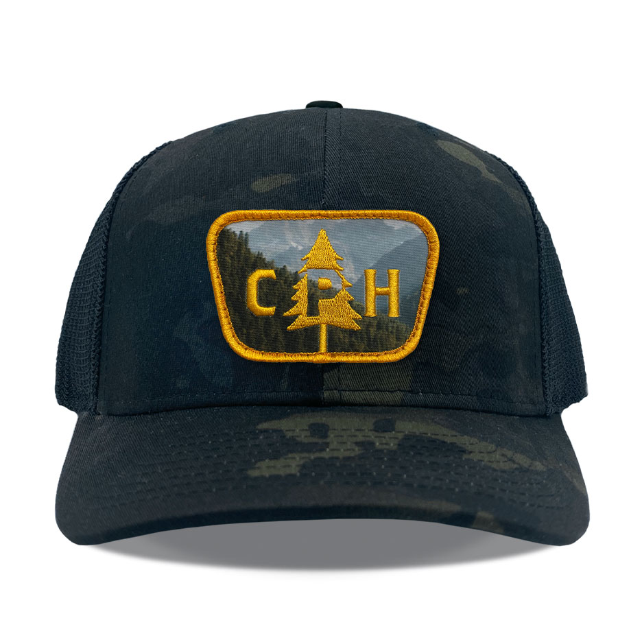 Yupoong 6006 charcoal/white, high-profile flat bill trucker, snapback closure. Hat