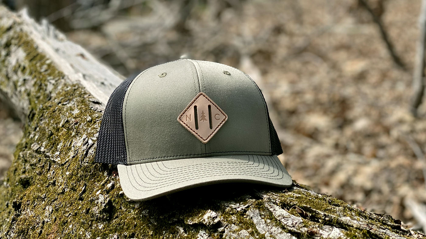 cutout leather patch hat NC themed hat in the forest