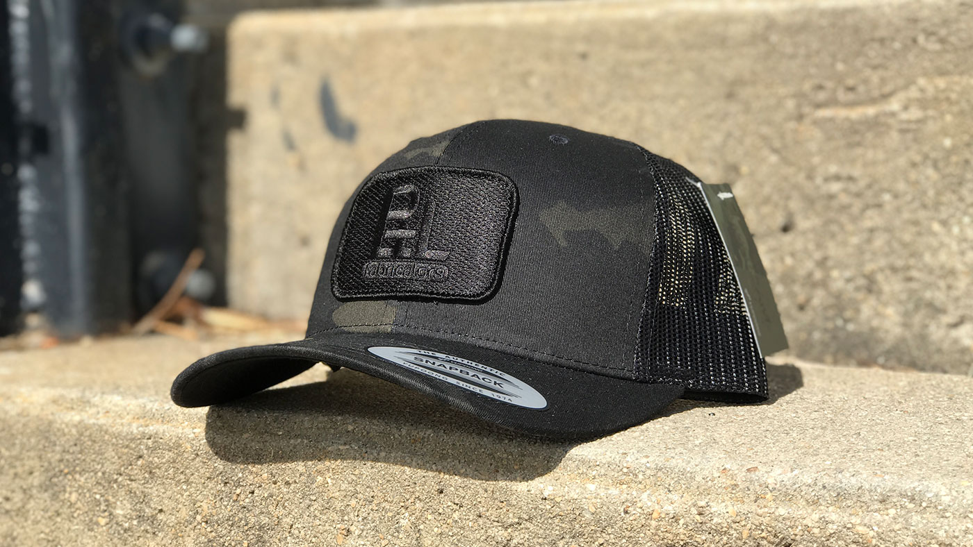 Multicam Patch Hat Black patch on a Black multicam Yupoong 6606 Trucker