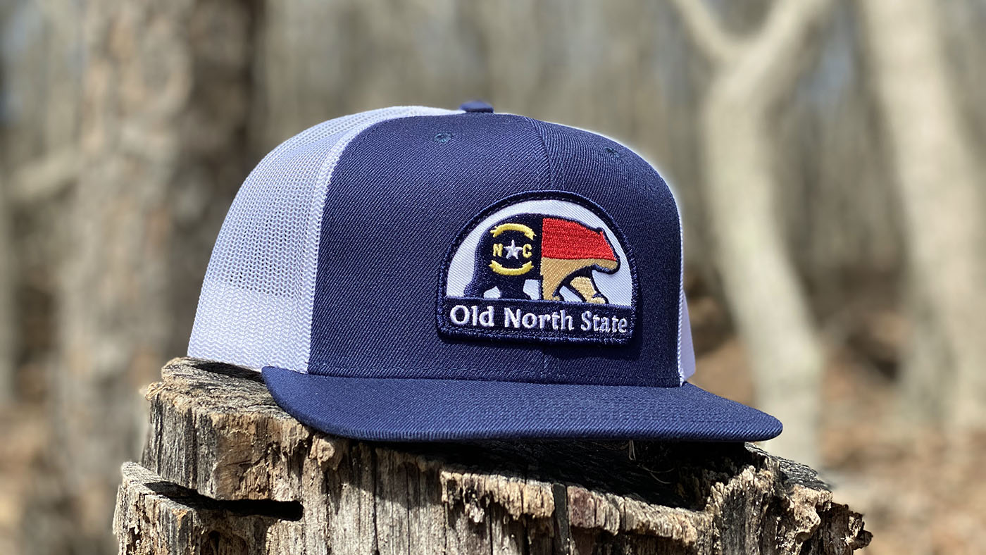 Custom Embroidered Patch Flat Bill Trucker Hat Old north state trucker hat on a log