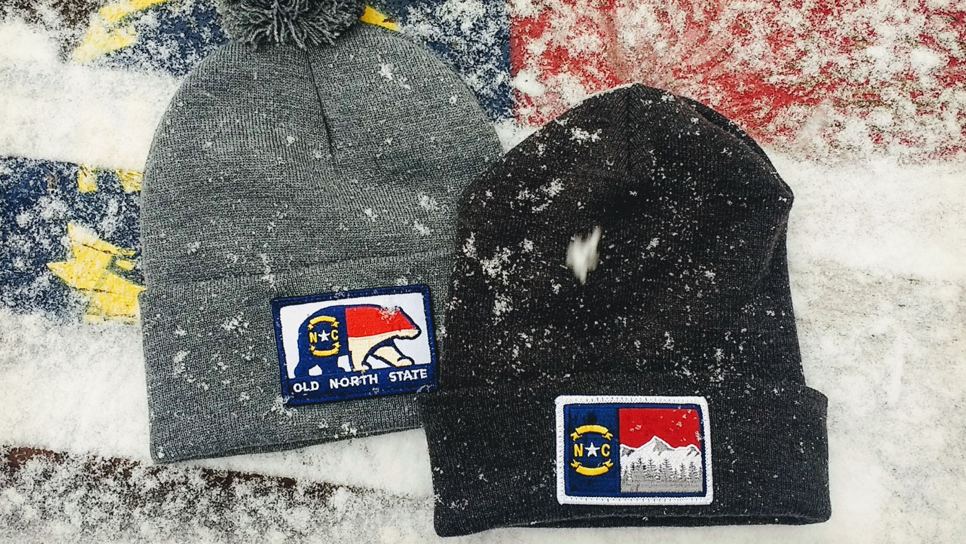 Custom Patch Winter Hats Two beanies in the snow with Old North State NC Patches