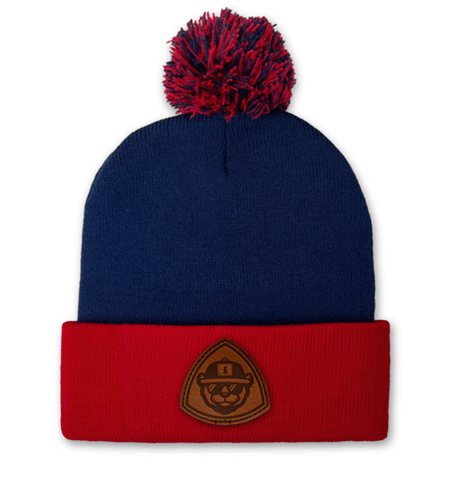 Sportsman pom-pom knit beanie with leather patch branding.