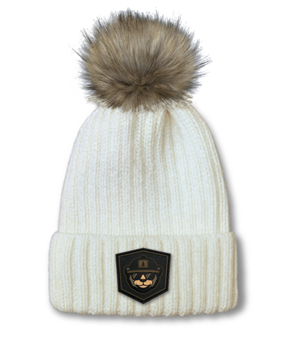 Port Authority cuffed pom beanie with PVC rubber patch logo.