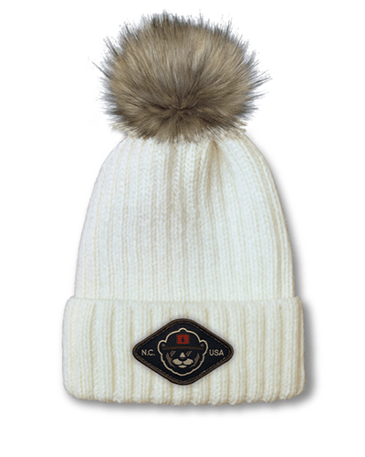 Port Authority pom beanie with woven patch logo, custom winter hat.