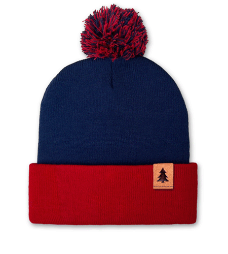 Custom pom beanie with suede clip label logo placement.